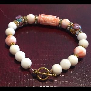 Handmade white / angel skin coral bracelet with carved coral center